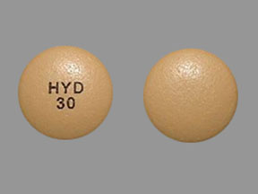 Hydrocodone tablets UK showing front and back view of prescription opioid pain relief medication tablets