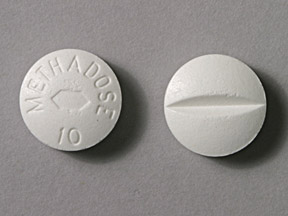 Methadone 10 mg UK Methadone 10 mg UK tablet shown in close-up view displaying its shape, colour, and surface markings.