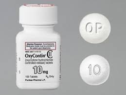 OxyContin 10 mg UK Grey, round, convex OxyContin 10 mg prolonged-release tablet for UK reference, marked "OP" on one side and "10" on the other