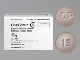 OxyContin 15 mg UK Grey, round, convex OxyContin 15 mg prolonged-release tablet for UK reference, marked "OP" on one side and "15" on the other