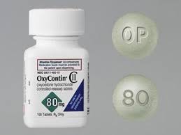 Green round OxyContin 80 mg prolonged-release tablet for UK reference, marked “OP” on one side and “80” on the other
